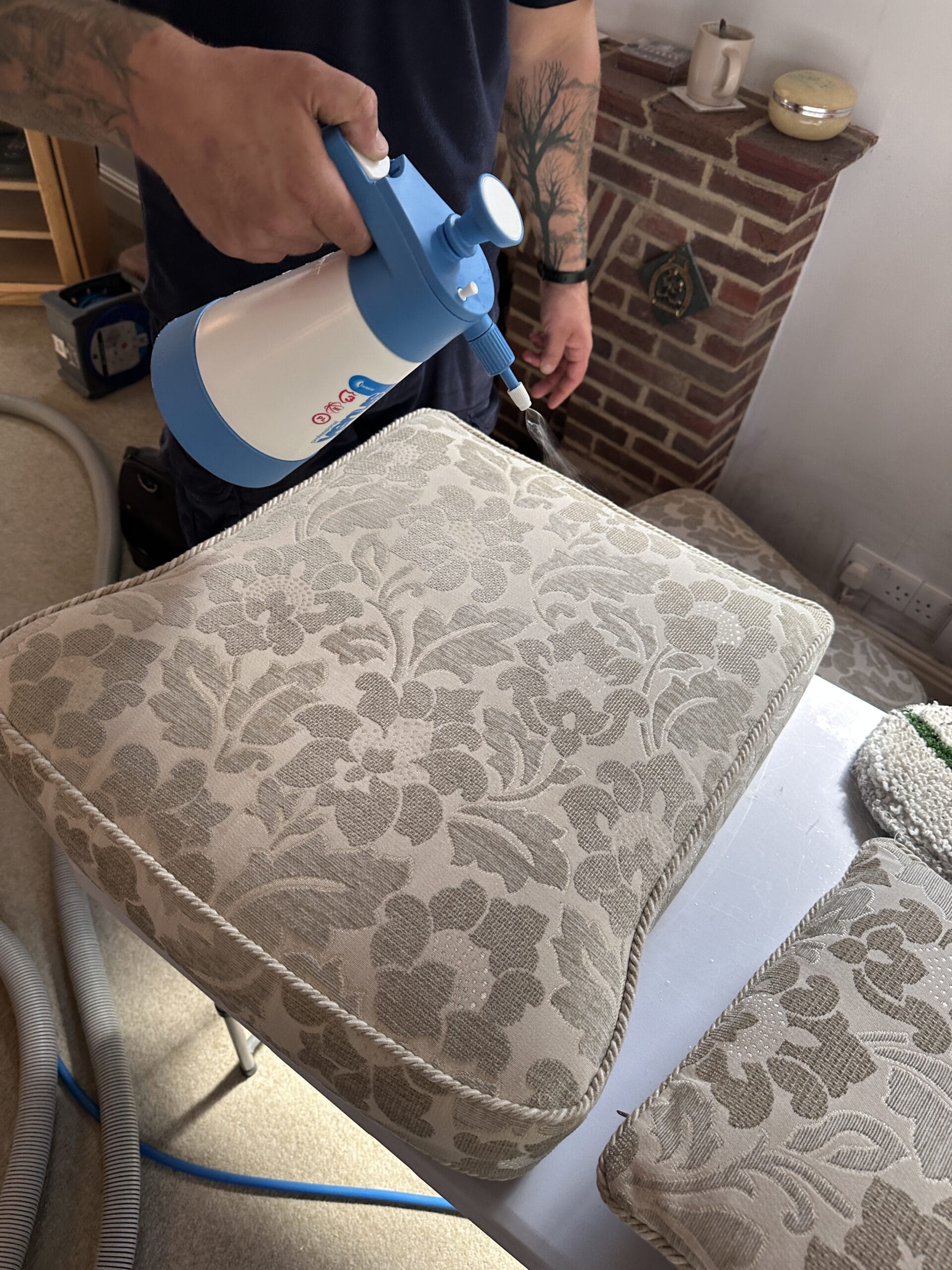connor pre spraying sofa cushions for cleaning